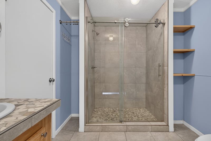 Glass-enclosed shower with tile surround at 2549 Snapdragon Ave, Middleburg, FL 32068
