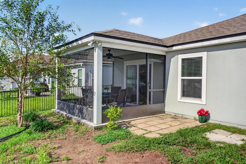 Back exterior with covered patio and sliding doors at 589 Seville Pkwy, St. Augustine, FL