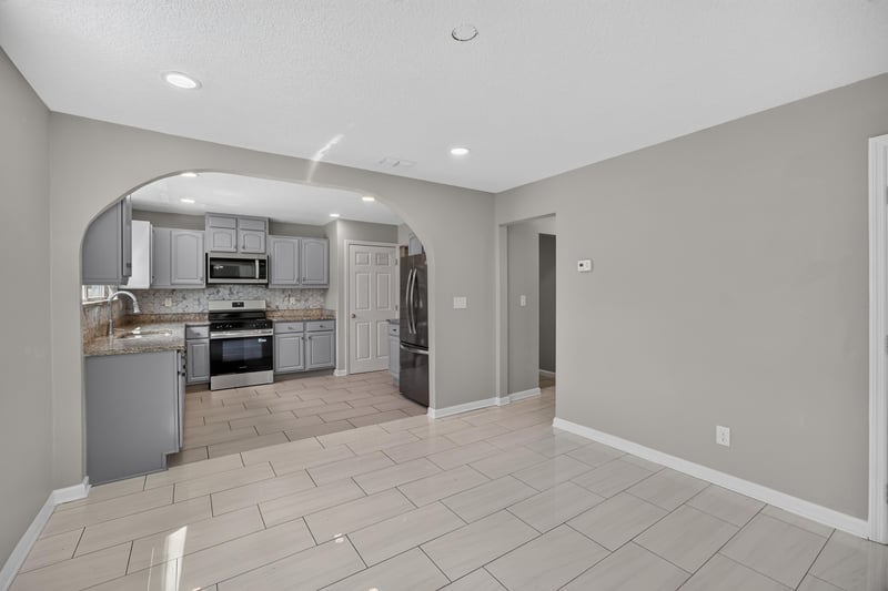 Kitchen archway view with tile flooring at 7015 Miss Muffet Ln N, Jacksonville, FL 32210