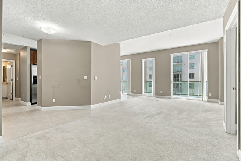 Empty living room with balcony access, photographed by Megapixeler on Riverplace Blvd, Jacksonville
