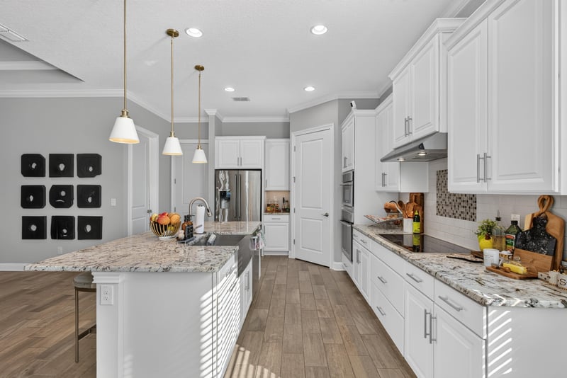 Kitchen with white cabinets and double wall oven at 3328 Southern Oaks Dr, Green Cove Springs, FL 32043