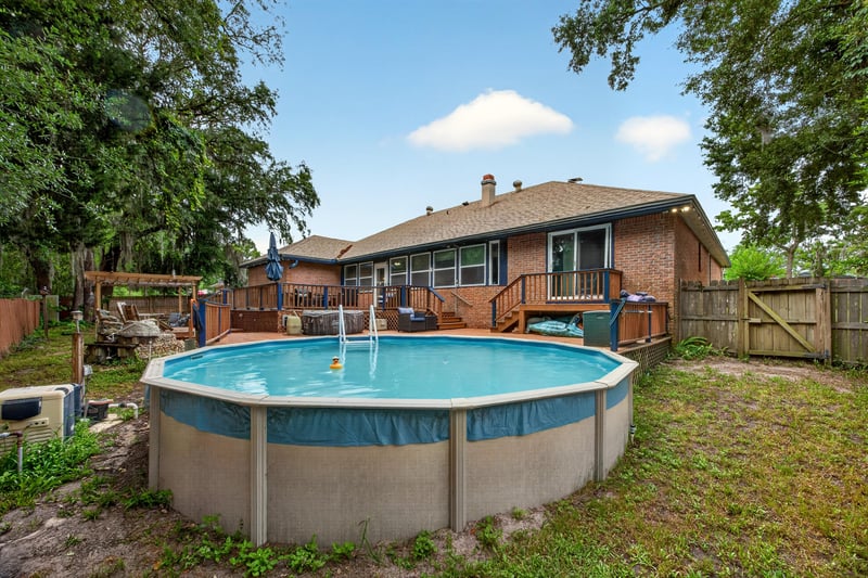 Backyard above ground pool and fenced yard at 981 Marble Ridge Dr, Orange Park, FL 32065