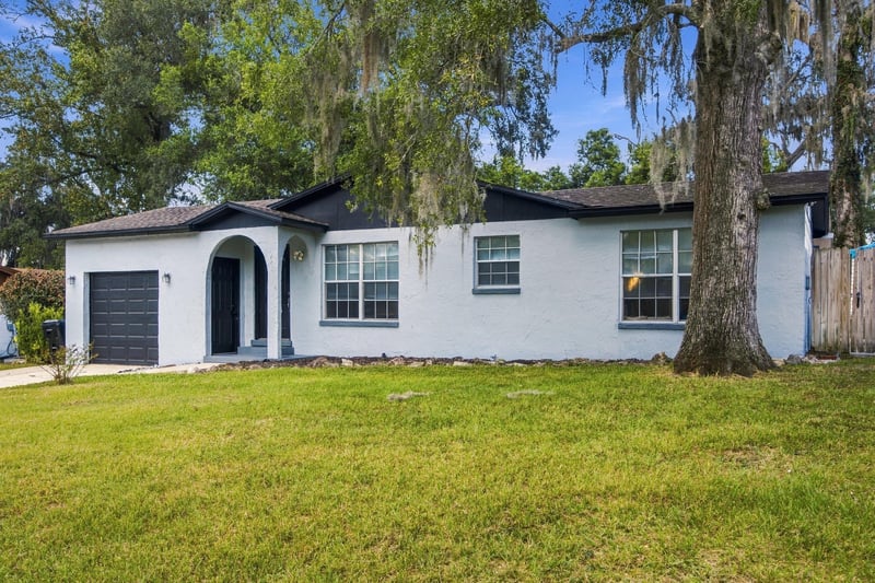 Wide front exterior view with oak trees at 417 Capricorn Ln, Orange Park, FL 32073