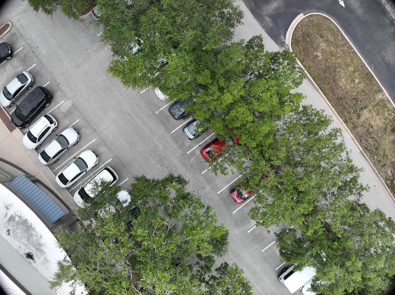 Aerial view of parking rows and oak tree line at 9406 Atlantic Blvd, Jacksonville, FL 32225
