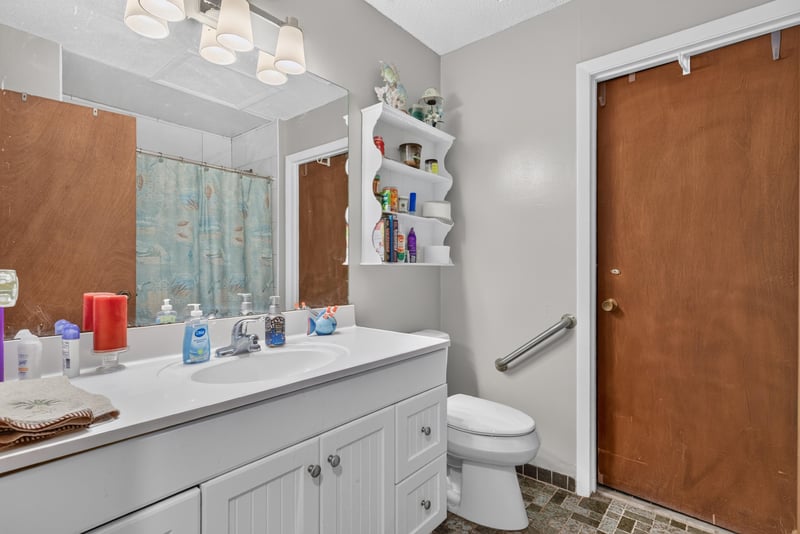 Bathroom vanity with storage shelving at 3249 Maryland Ave, Green Cove Springs, FL