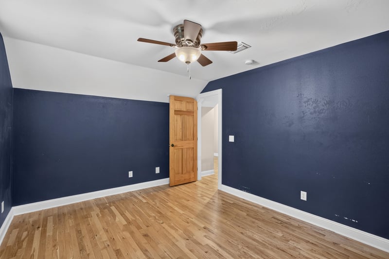 Bedroom with navy walls and ceiling fan at 1735 Hagans Ridge Ct