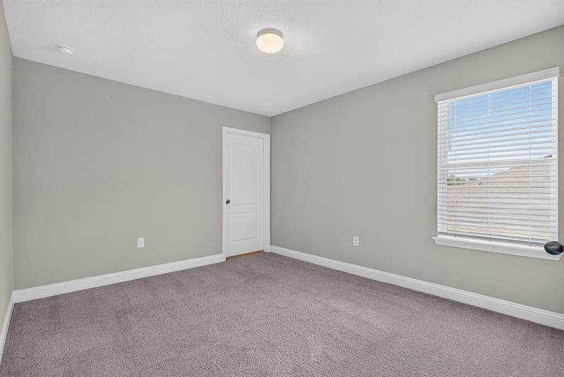 Carpeted bedroom with single window at 2580 Cold Stream Ln, Green Cove Springs, FL 32043