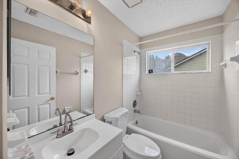 Bathroom with vanity mirror and tub-shower combo at 6646 Shiloh Creek Dr