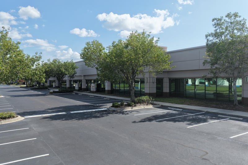 Parking lot and building edge with palm trees at 10550 Deerwood Park Blvd, Jacksonville, FL 32256