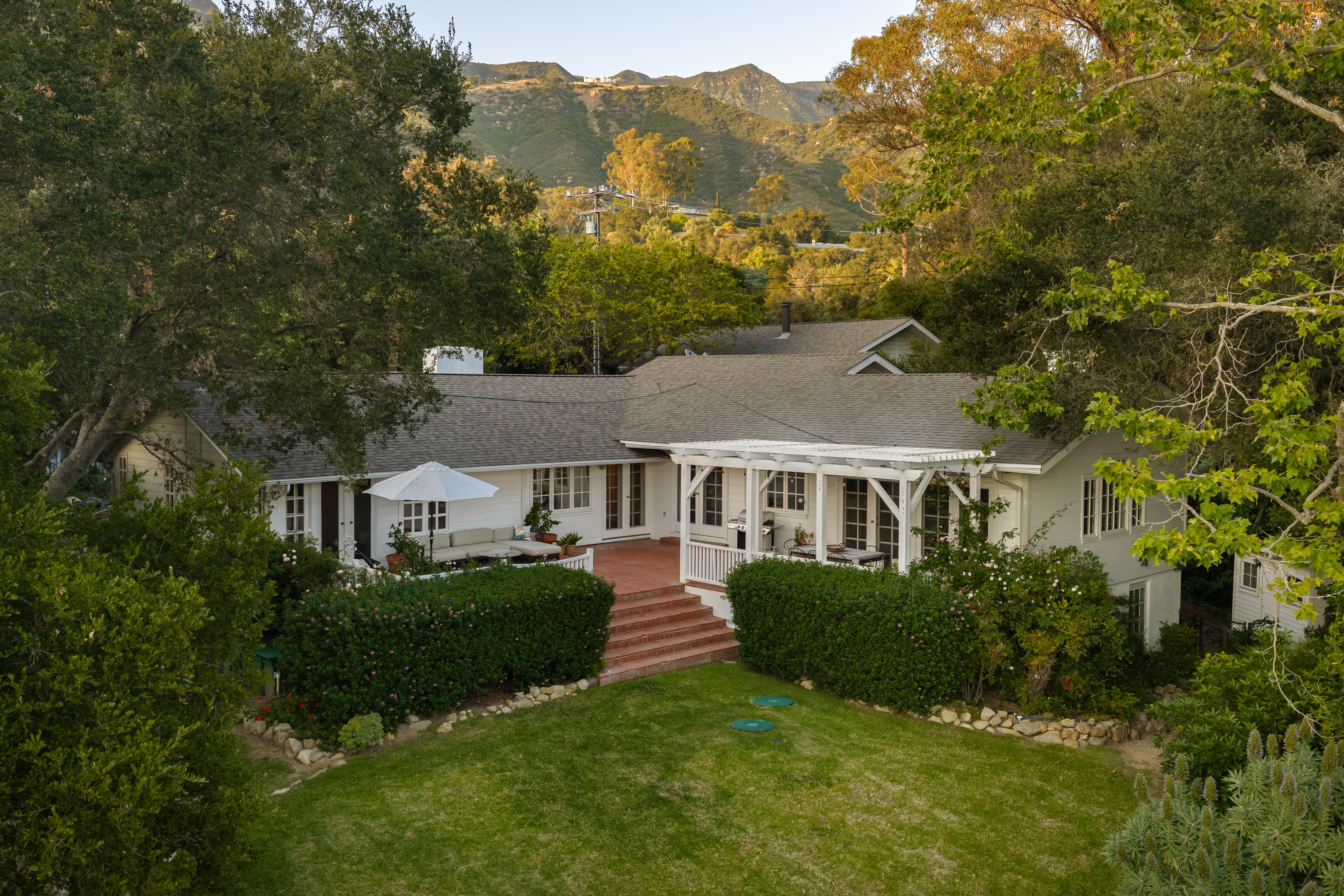 Aerial drone photography of 2915 Hidden Valley Ln, Santa Barbara CA — sweeping elevated perspective reveals the property's relationship to the surrounding Montecito foothills and mature tree canopy in this real estate drone photography series by VirTour Media. Our team captured still photography, aerial drone photography, and twilight photography from late afternoon through twilight.