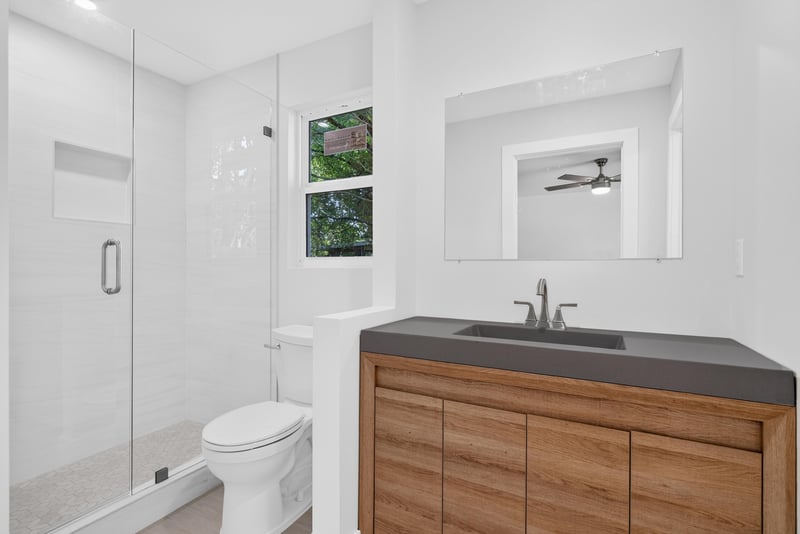 Bathroom with glass shower, toilet, and vanity at 8453 Boysenberry Ln W, Jacksonville, FL