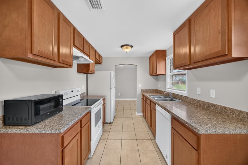 Kitchen with wood cabinets and white range at 1143 Tumbleweed Dr, Orange Park, FL 32065