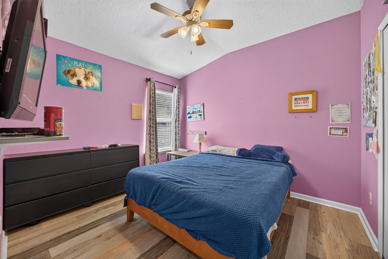 Bedroom with pink walls and television at 2065 Creekmont Dr