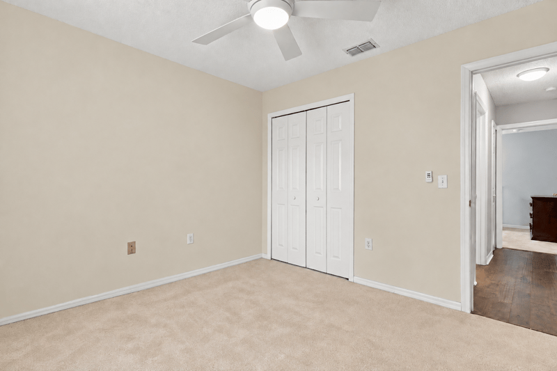 Bedroom with carpet and closet door at 11197 Illford Dr