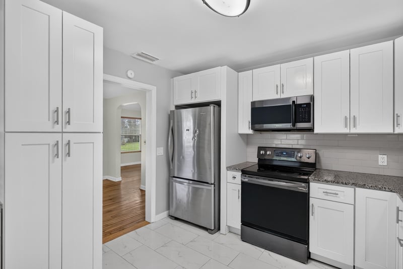 Kitchen view toward tile floor and pantry cabinet at 217 Baisden Rd, Jacksonville, FL 32218