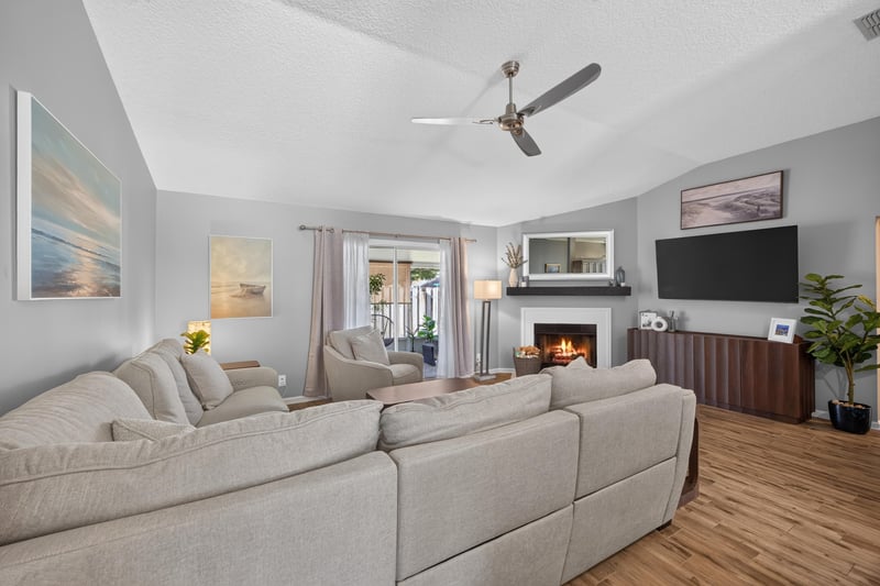 Living room with sectional sofa and fireplace mantel at 12825 Kelsey Island Dr, Jacksonville, FL 32224