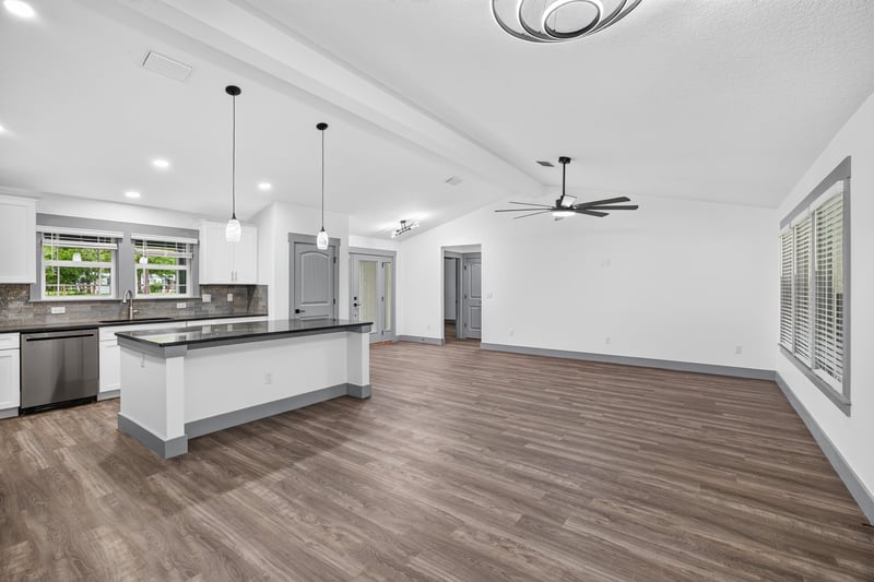 Open living and kitchen area with ceiling fan at 4800 Acacia St, Middleburg, FL 32068