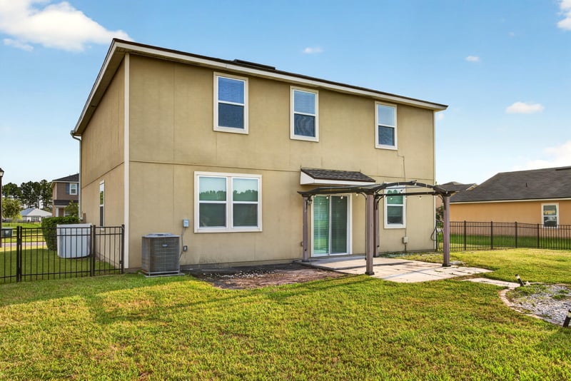 Backyard patio with pergola and seating at 6830 Hanford St, Jacksonville, FL 32219