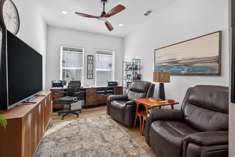 Living room with leather recliners and bookshelf at 129 Amberwood Dr, St. Augustine, FL