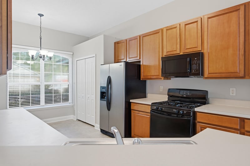 Kitchen corner with black appliances and window over sink at 14187 Big Spring St, Jacksonville, FL 32258