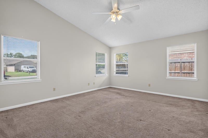 Empty bedroom with ceiling fan and two windows at 400 Ashcroft Landing Dr, Jacksonville, FL 32225
