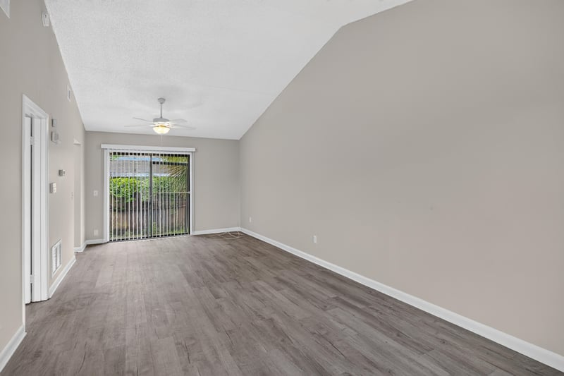 Living area with vaulted ceiling and wood-look flooring at 2717 Trollie Ln, Jacksonville, FL