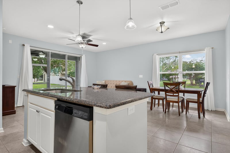 Kitchen island with dining table and windows beyond at 2378 Caney Oaks Dr, Jacksonville, FL