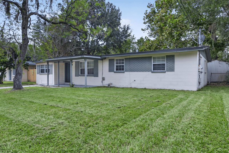 Front elevation with wide lawn at 5812 Tampico Rd, Jacksonville, FL 32244