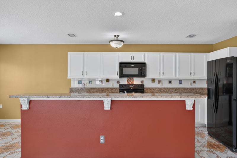 Kitchen with granite counters and black appliances at 2282 Justin Lake Dr, Jacksonville, FL