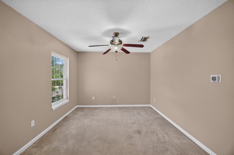 Bedroom with carpet and ceiling fan at 1572 Biscayne Bay Dr, Jacksonville, FL 32218