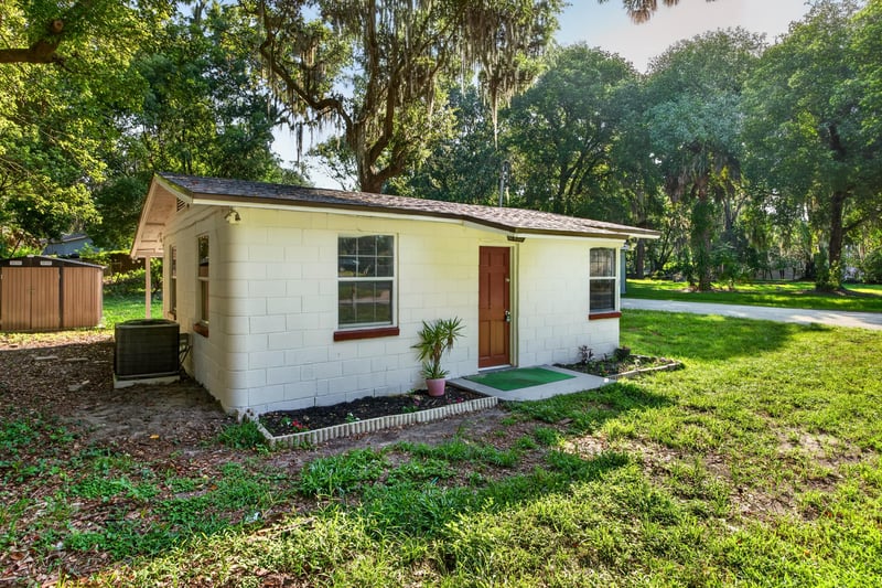 Front exterior view of white block home at 4951 Halls Dr