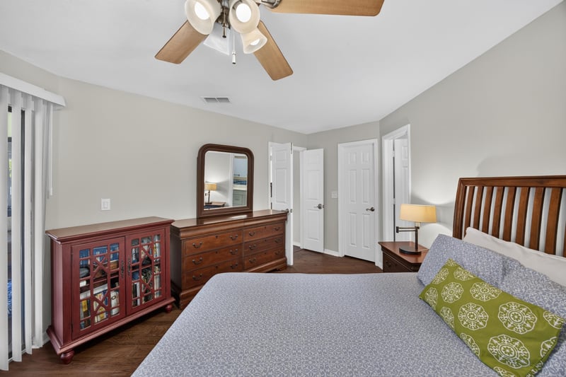 Bedroom with bed and wood dresser at 10150 Belle Rive Blvd, Jacksonville, FL
