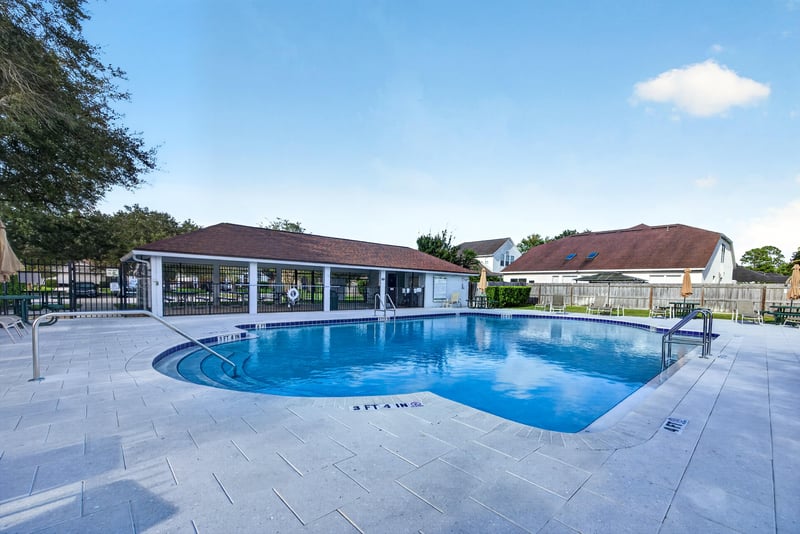 Community pool deck and seating area in Johns Creek
