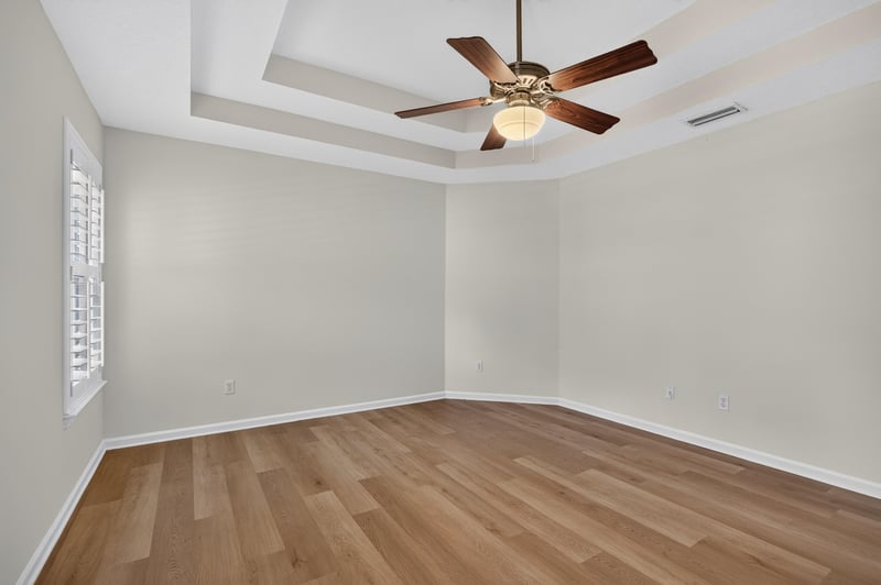 Bedroom with tray ceiling and ceiling fan at 2131 E Stone Creek Dr, Fleming Island, FL