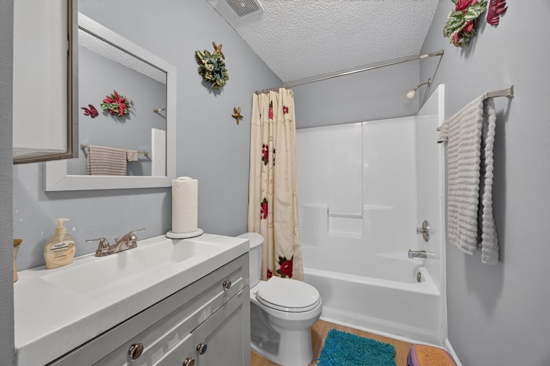 Bathroom with white vanity and tub-shower at 5375 Dodge Rd, Jacksonville, FL 32209