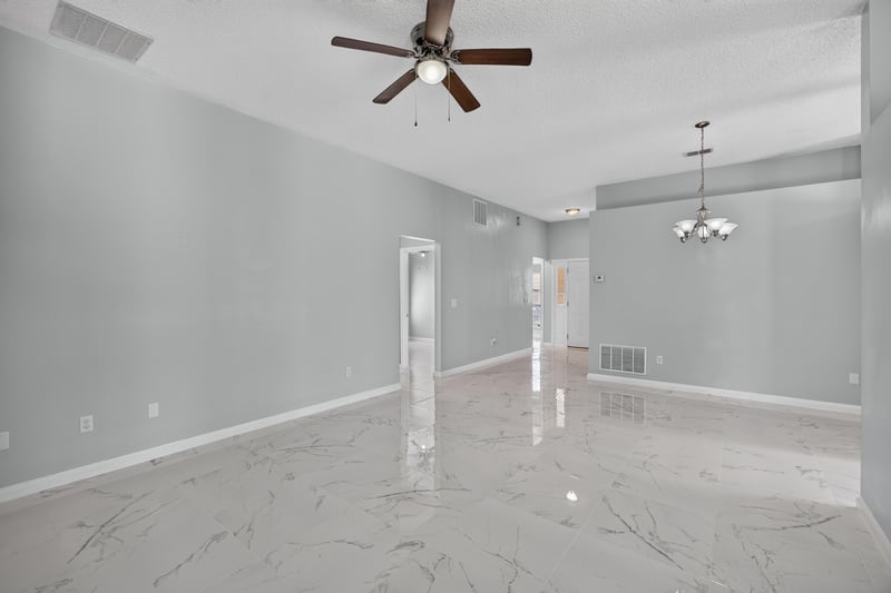 Living room with ceiling fan and view toward dining area at 490 Hillside Dr, Orange Park, FL 32073