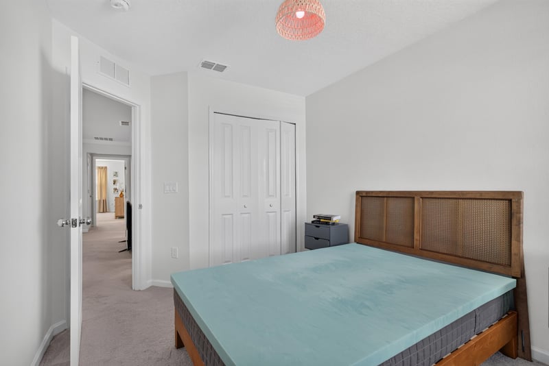 Secondary bedroom with bed near hallway door at 1186 Beach Dune Dr, Jacksonville, FL 32233