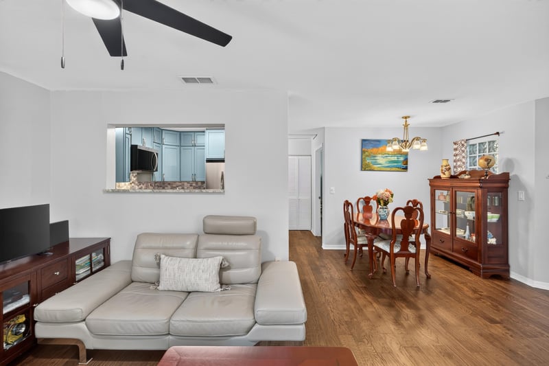 Living room with sofa and wall-mounted TV at 10150 Belle Rive Blvd, Jacksonville, FL
