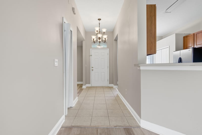 Hallway view toward kitchen pass-through with chandelier at 14187 Big Spring St, Jacksonville, FL 32258