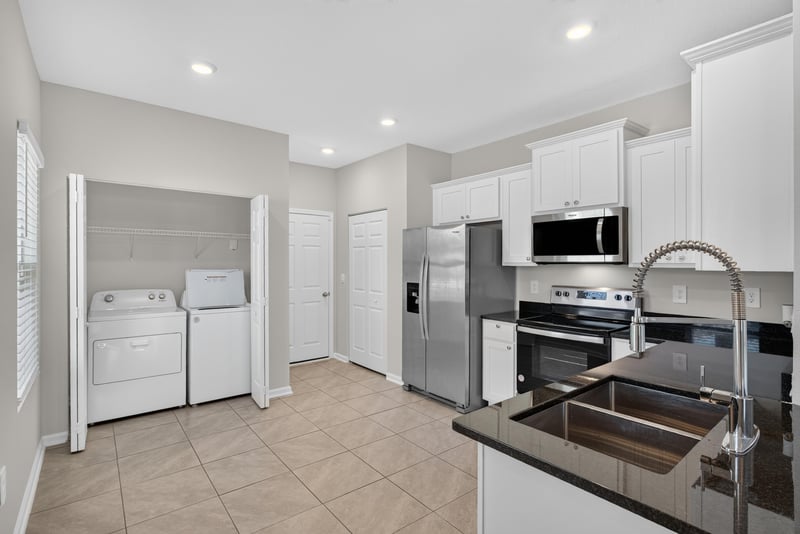Laundry closet with stacked washer and dryer at 4024 Bay Hawk Ct, Jacksonville, FL