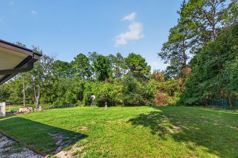 Aerial view of the backyard lawn and tree line at 2435 Range Line Rd, Middleburg, FL