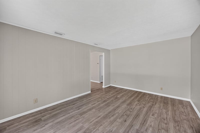Empty room with wood-look flooring and hallway view at 5527 Beney Rd, Jacksonville, FL 32207