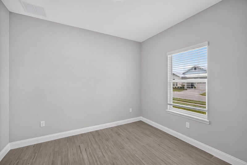 Bedroom with a window to the side yard at 91 Tilloo Ct, St. Johns, FL
