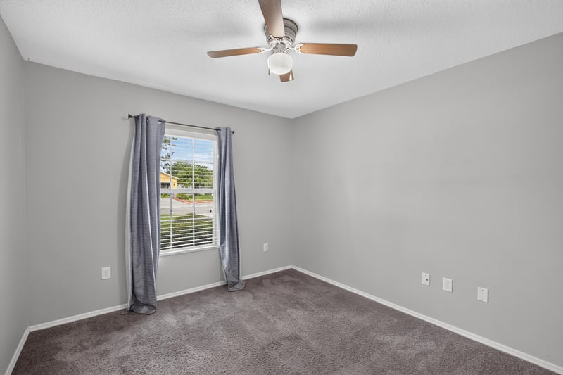 Empty bedroom with blue accent walls at 7545 Lirope St, Jacksonville, FL 32244