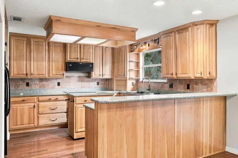 Kitchen wood cabinetry and overhead lighting at 2915 Trenton Ct, Orange Park, FL