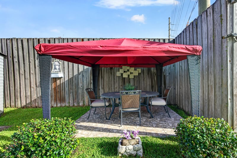 Patio with red umbrella and seating at 6931 Cane Grass Ln E, Jacksonville, FL 32244