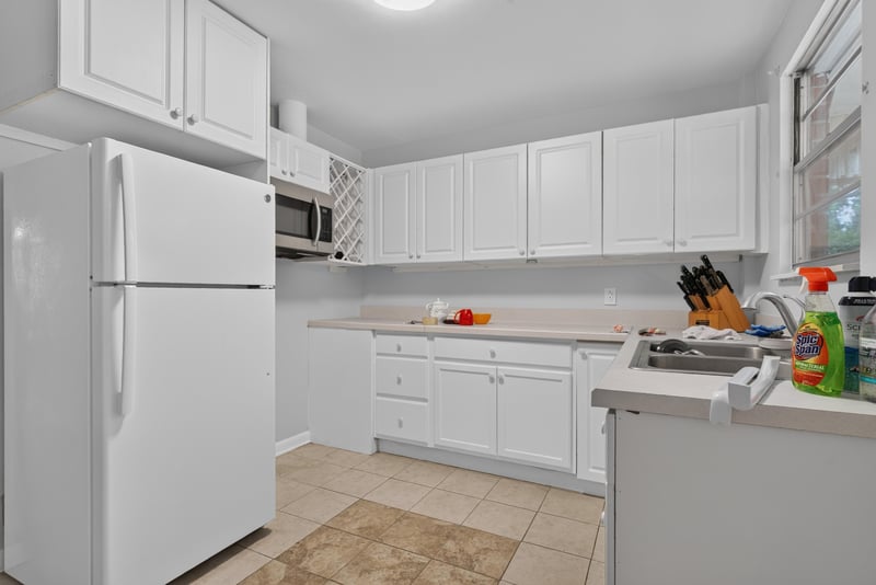Second kitchen with white cabinets and tile floor at 5745 110th St, Jacksonville, FL 32244