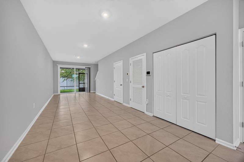 Entry hallway with tile floor and closet doors at 2837 Black Buck Cir, Jacksonville, FL 32225