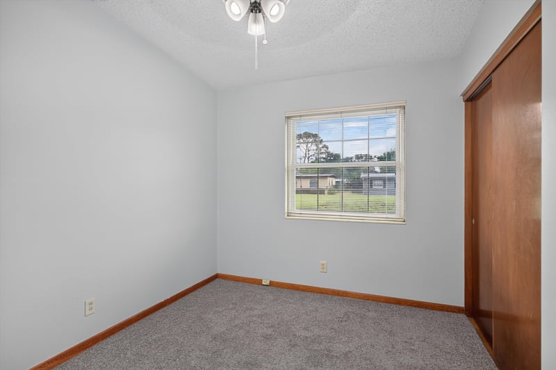 Carpeted bedroom with window at 11462 Elane Dr, Jacksonville, FL