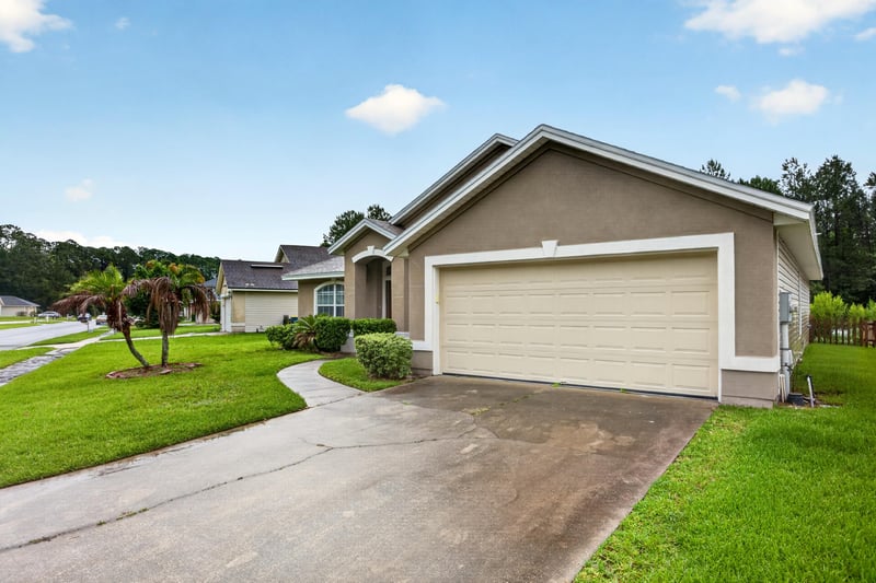 Front exterior with garage and driveway at 706 Bonaparte Dr, Jacksonville, FL 32218